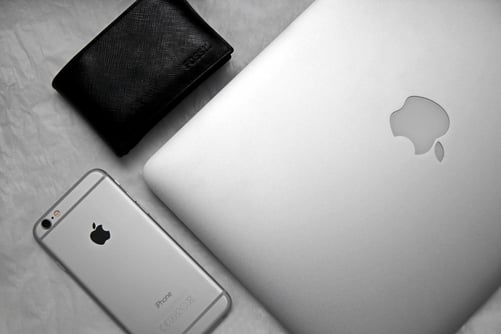 A wallet, an iPhone and a MacBook