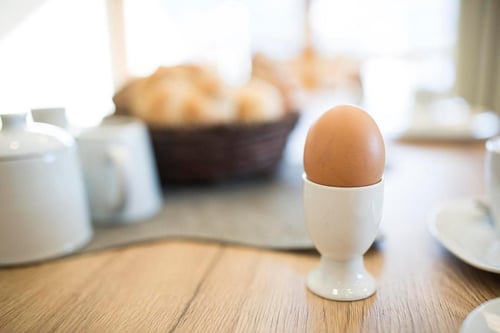 Egg in egg cup on table