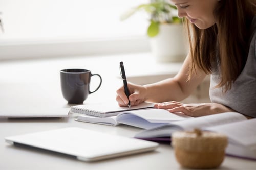 Woman writing in notebook