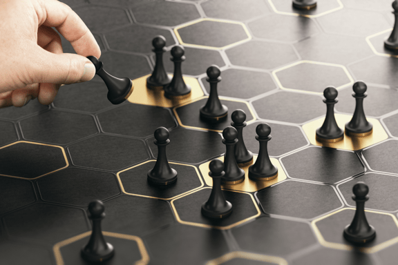 a hand playing chess on a black chess board