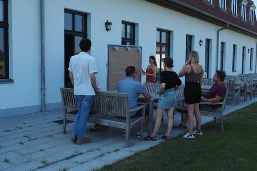 SuitePad team discussing values in front of a board outside