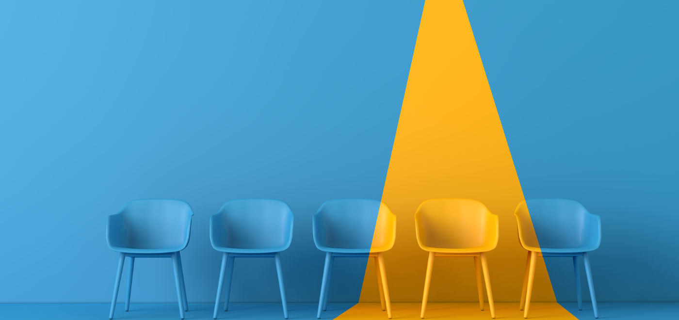 one yellow chair standing out amongst four blue chairs